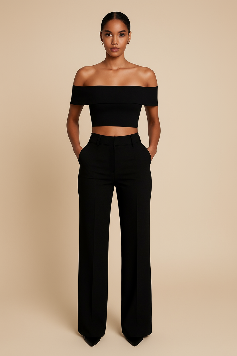 Woman wearing a black off-shoulder top and high-waisted pants on a beige background