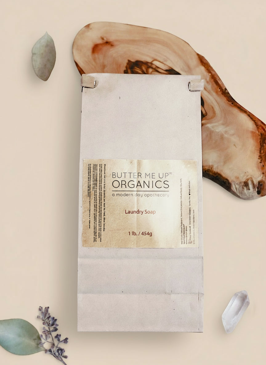 Butter Me Up Organics laundry soap package on a wooden surface