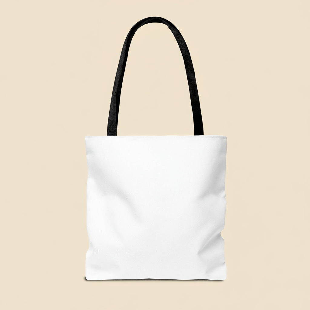 White tote bag with black handle on a tan background