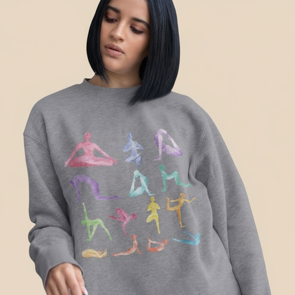 Woman wearing a gray sweatshirt with colorful yoga pose illustrations.