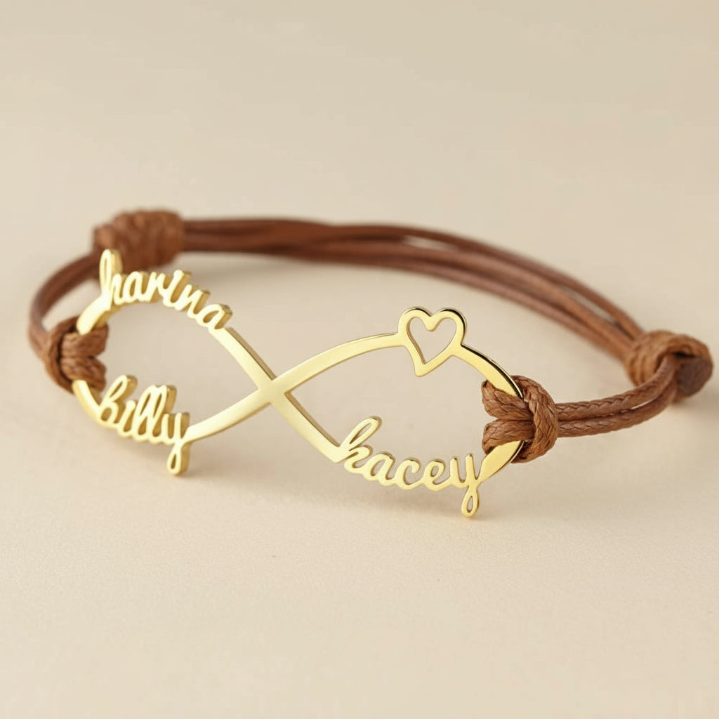 Gold bracelet with interlocking name charms on a beige background