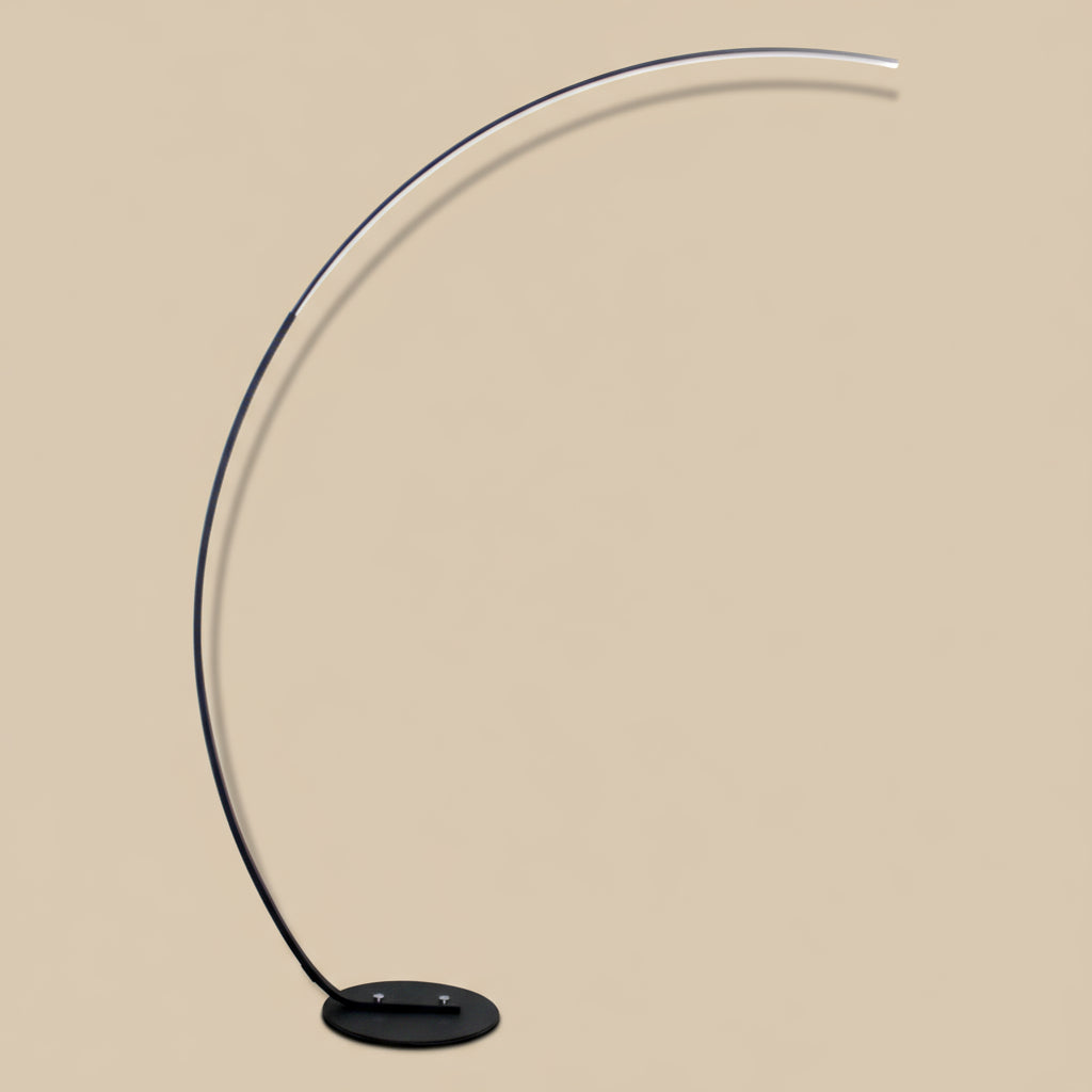 Modern floor lamp with a curved design on a white background