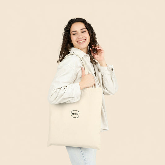 Model carrying Meow Tote Bag in canvas color