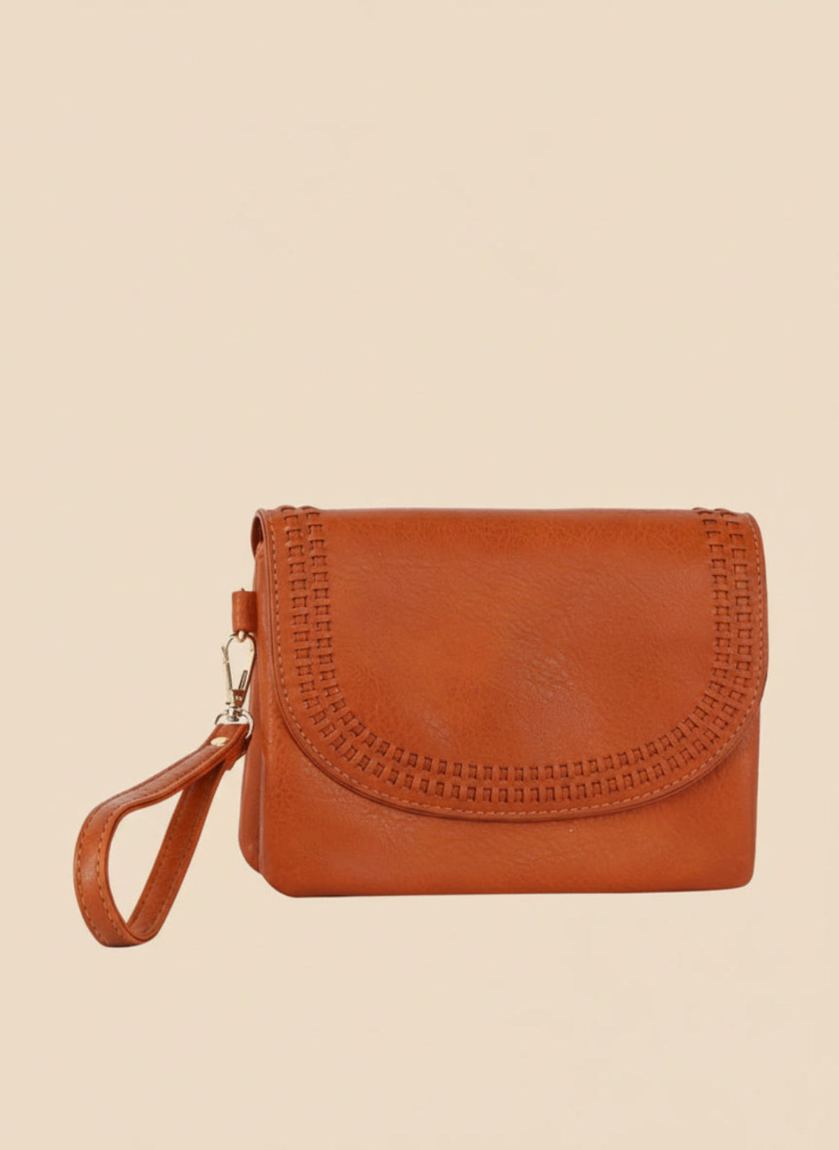 orange brown leather clutch bag with wrist strap on a white background
