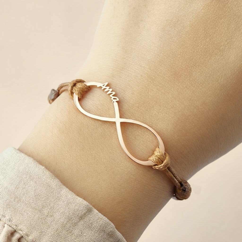 Infinite bracelet with names on a wrist against a light background