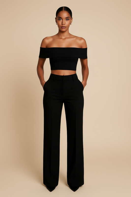 Woman wearing a black off-shoulder top and high-waisted pants on a beige background