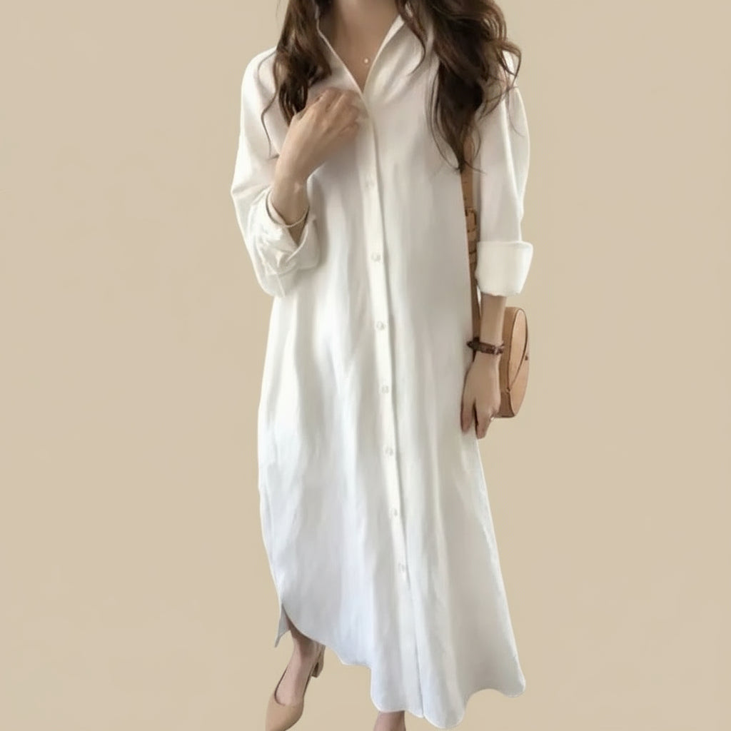 Woman wearing a white dress in a in front of a beige background