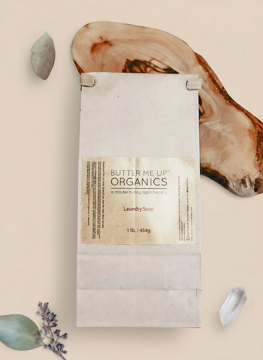 Butter Me Up Organics laundry soap package on a wooden surface