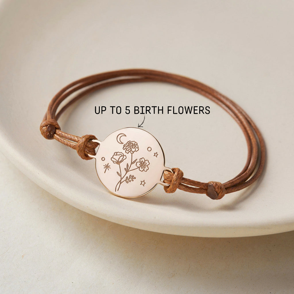 Bracelet with engraved design on a white plate, featuring text about birth flowers.