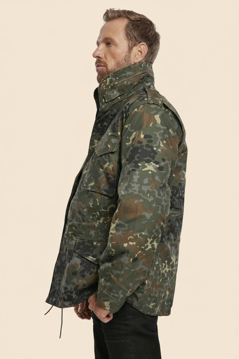 Man wearing a camouflage jacket on a tan background
