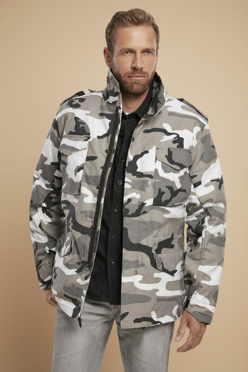 Man wearing a camouflage jacket on a tan background