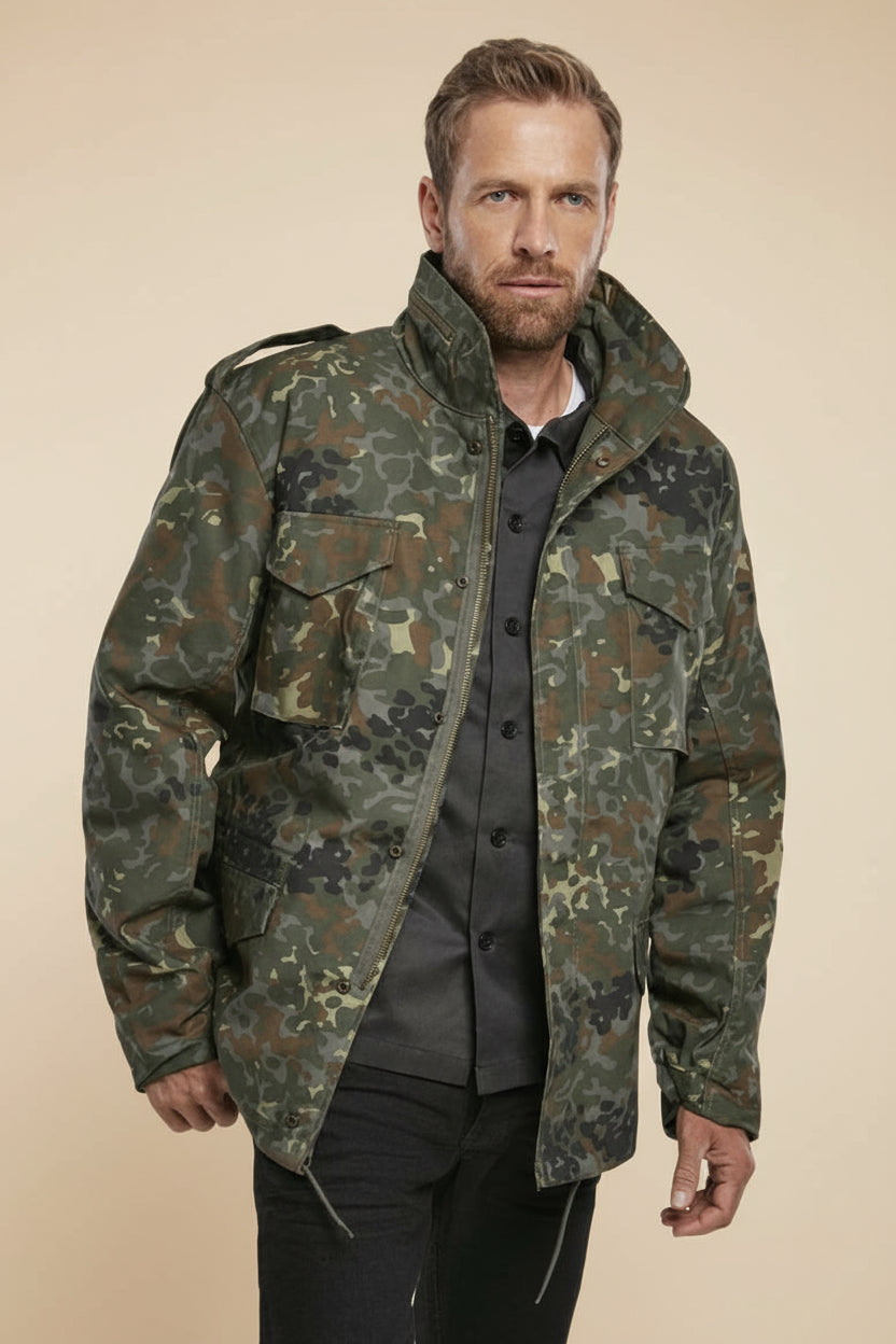 Man wearing a camouflage jacket on a tan background