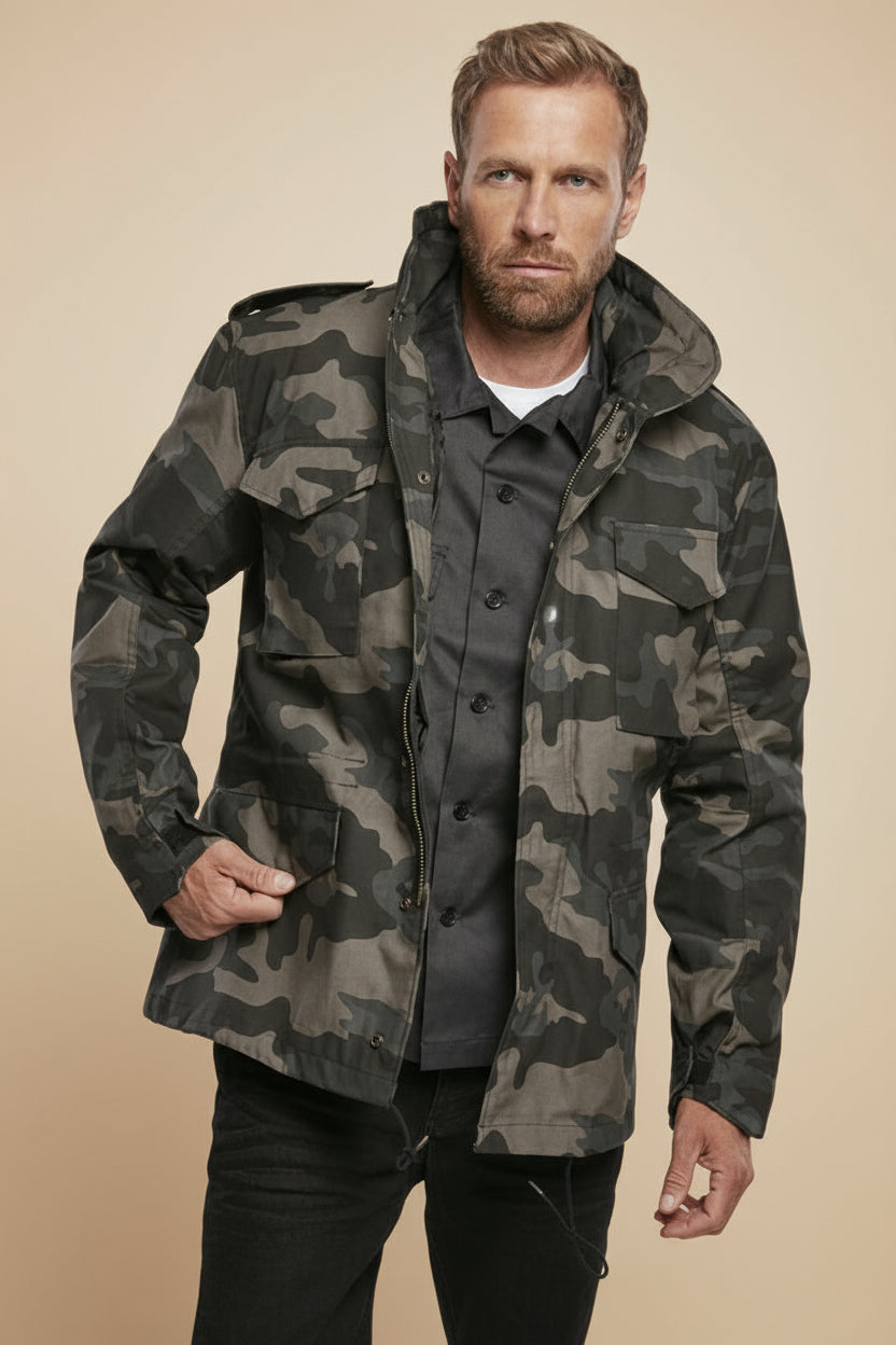 Man wearing a camouflage jacket on a tan background