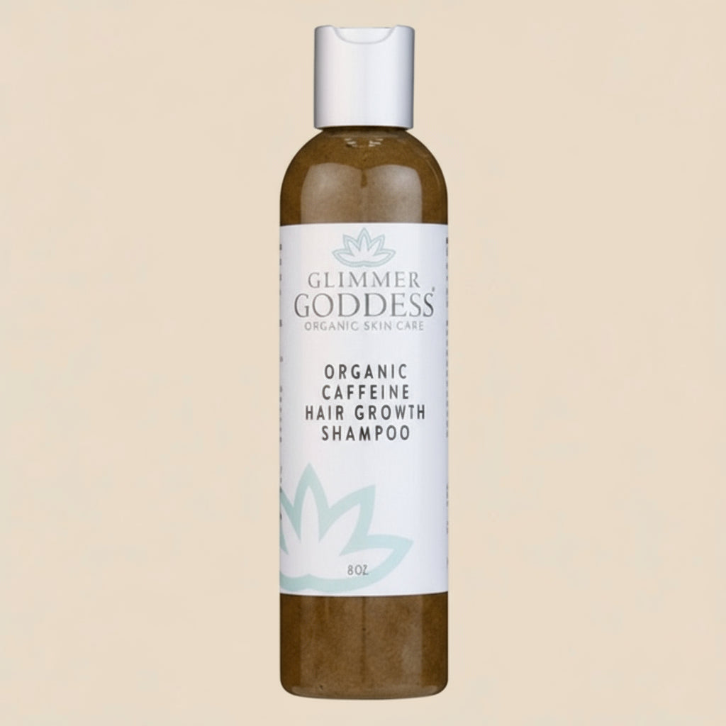 Glimmer Goddess organic caffeine hair growth shampoo bottle on a tan background